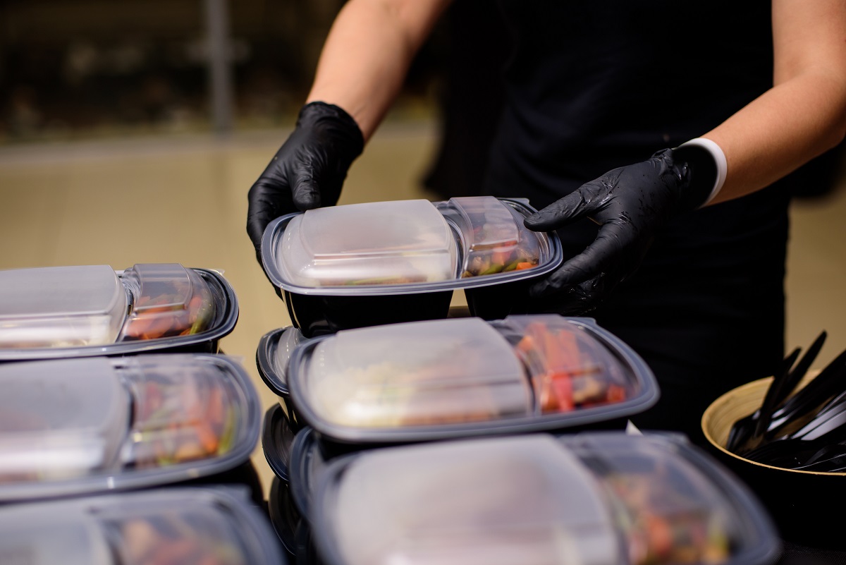 Lunch box with food in the hands. Catering